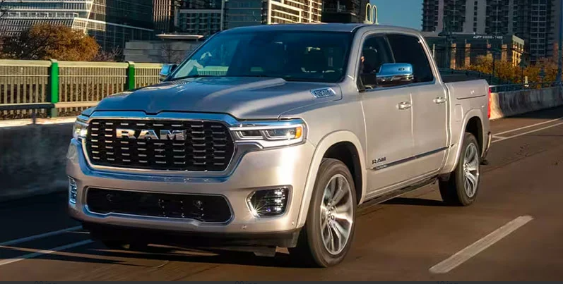 A 2025 Ram 1500 driving down the road.