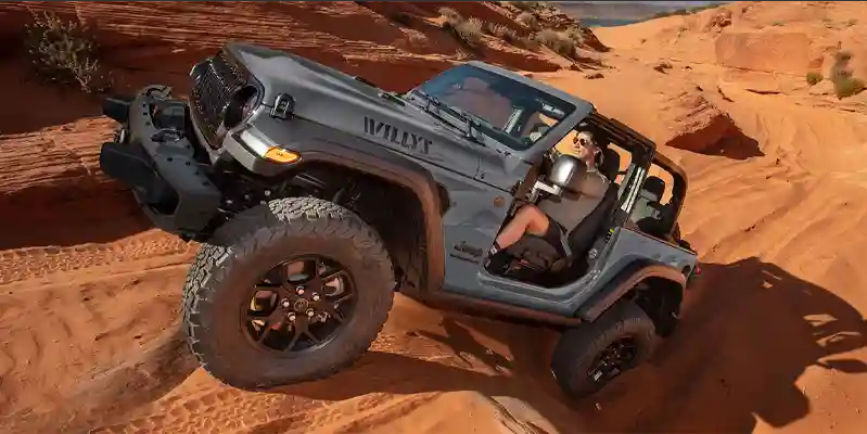 A man off-roading in a 2025 Jeep Wrangler.