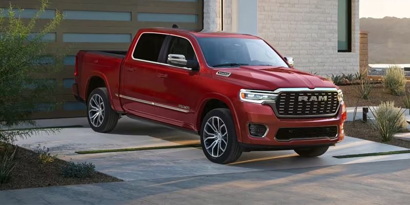 Red 2026 RAM 1500 standing outside the garage on its good front profile looks