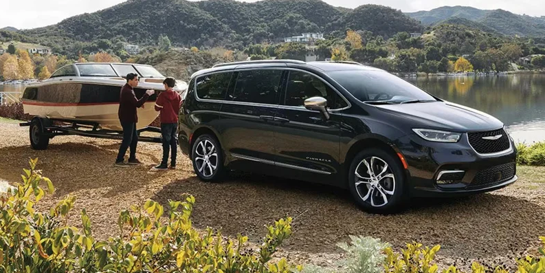 A photo of the 2026 Chrysler Pacifica towing a boat.