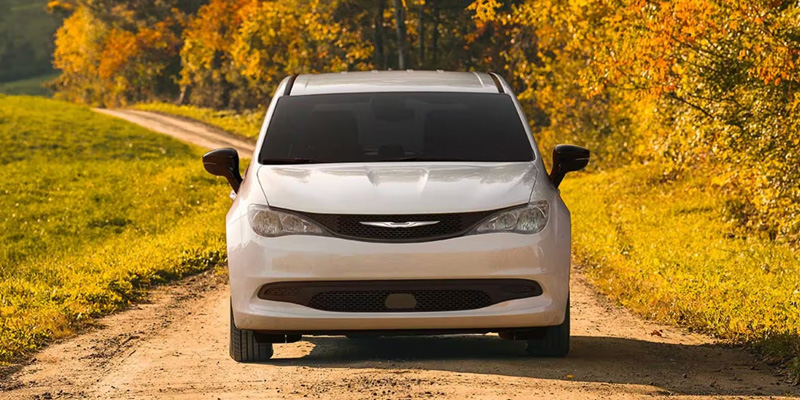 2026 White Chrysler Voyager Stopped between the grass and forest