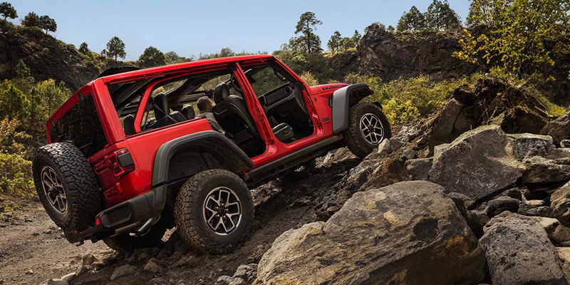 2026 Red Jeep® Wrangler climbing Rocks